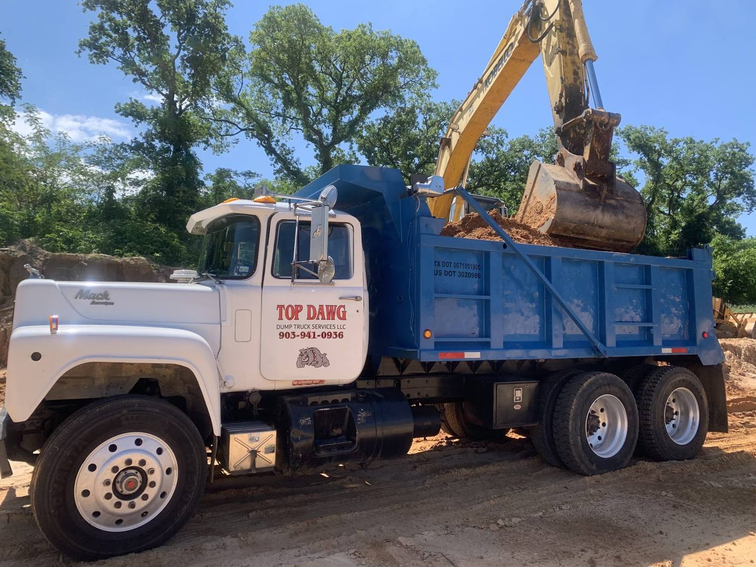 White Top Dawg dump truck being loaded
